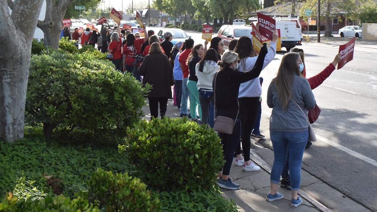 Nurses rally along Orangeburg Avenue in front of Doctors Medical Center on Wednesday, April 27, 2022, to share the message that understaffing isn’t safe for patients. A music system played a steady stream of songs, including at one point “Bad Medicine” by Bon Jovi.