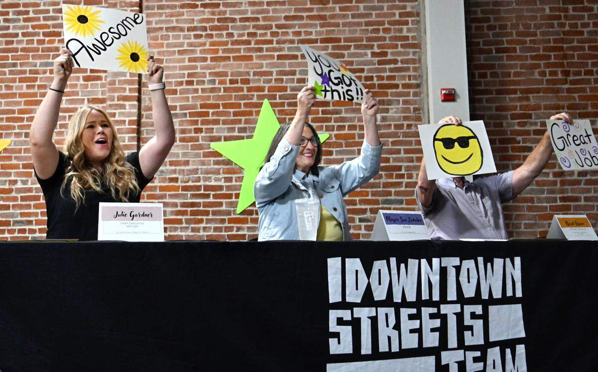 Downtown Streets Team CEO Julie Gardner, left, Modesto Mayor Sue Zwhalen and Brad Hahn serve as judges and hold up signs encouraging the performers during the DST’s talent show at the Martin G. Petersen Events Center in downtown Modesto, Calif., Friday, May 31, 2024.