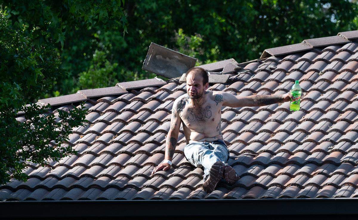 A man was arrested after climbing on the roof of the Church of Jesus Christ of Latter-Day Saints church on Dale Road in Modesto, Calif., on Tuesday, April 26, 2022. The man ripped up and destroyed dozens of tiles on the church roof, the man agreed to leave if police gave him a cigarette and a soda. The officers complied, and the man agreed to leave after smoking a cigarette and drinking a soda. He was taken into custody without any injuries to him, officers or members at the church.
