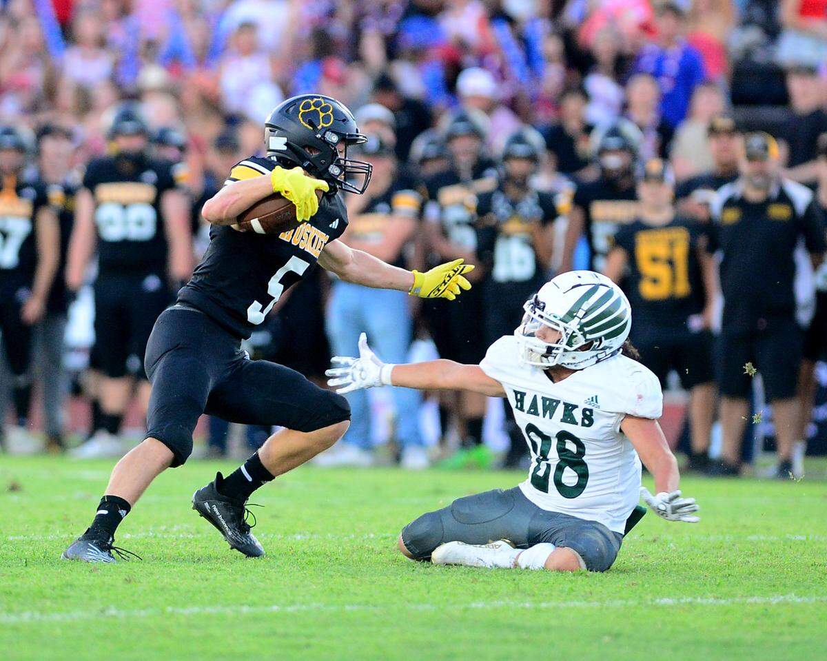 Hughson receiver Larkin Meyer jukes a Central Valley defender during a game between Hughson High School and Central Valley High School at Hughson High School in Hughson California on August 25, 2023.