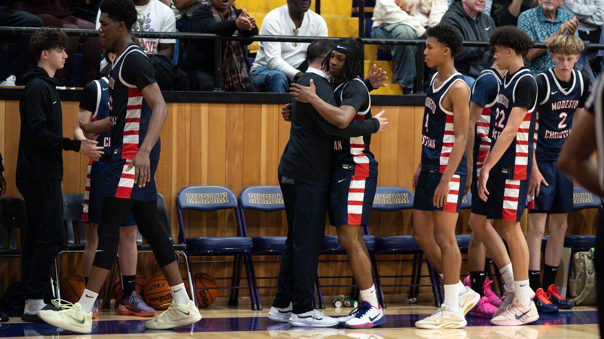 Modesto Christian head coach Chris Teevan greets Crusaders starters after they are subbed out in the fourth quarter during the CIF Northern California Open Division Regional Semifinals at Archbishop Riordan High School in San Francisco, Saturday, March 7, 2026.
