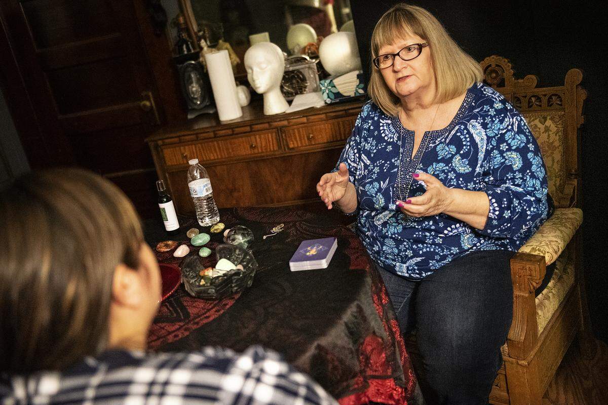 Gaylene Cornell, right, gives Jasmine Snyder a psychic reading at Daydreams and Nightmares in Modesto, Calif., Thursday, Oct. 17, 2019.