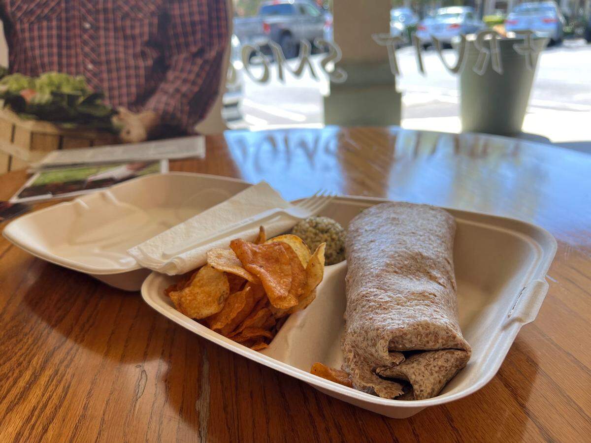 The Veggie Wrap at Village Health Foods is made with lettuce, tomato, onion, green olives, salsa, cucumber, avocado, vegan cream cheese and a sprouted wheat tortilla. It comes with a side a tabouli and barbecue chips for $11.95.