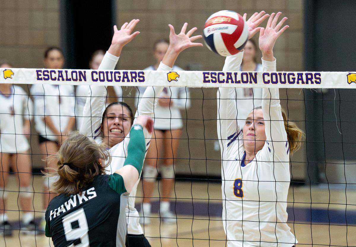 Escalon’s Chloe Green, right, blocks the shot of Liberty Ranch hitter Savannah Lethbridge during the Sac-Joaquin Section Division IV playoff match in Escalon, Tuesday, Oct. 28, 2025. 