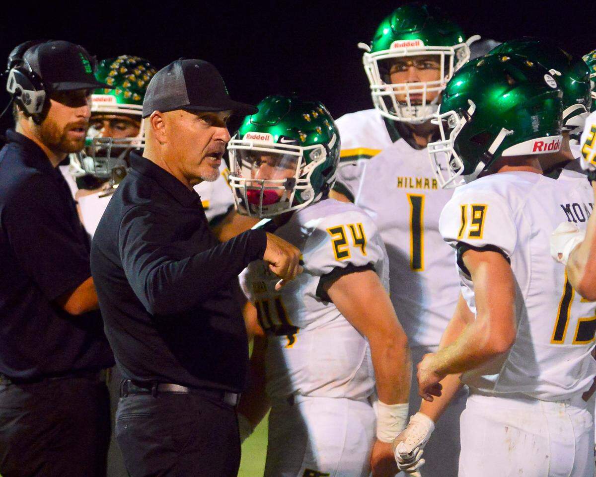 Hilmar Head Coach Frank Marques talks to his players during a timeout during a football game between Hilmar and Ripon High School at Ripon High School in Ripon CA on September 24, 2021