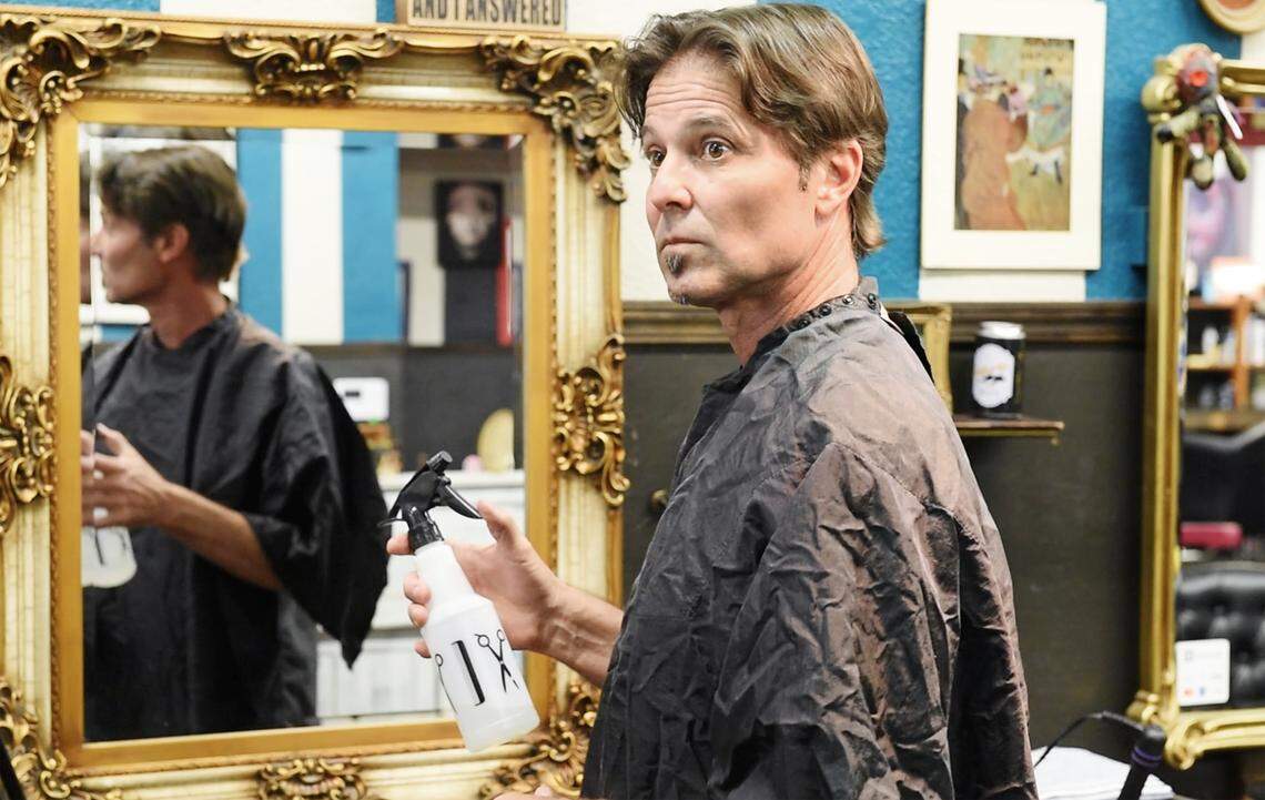 Bee photographer Andy Alfaro prepares to give himself a haircut with the coaching of hair stylists Tiffany Rose De La Cruz and LoveCore at Tangled T’s Hair Studio in Modesto, Calif., on Friday, April 24, 2020.