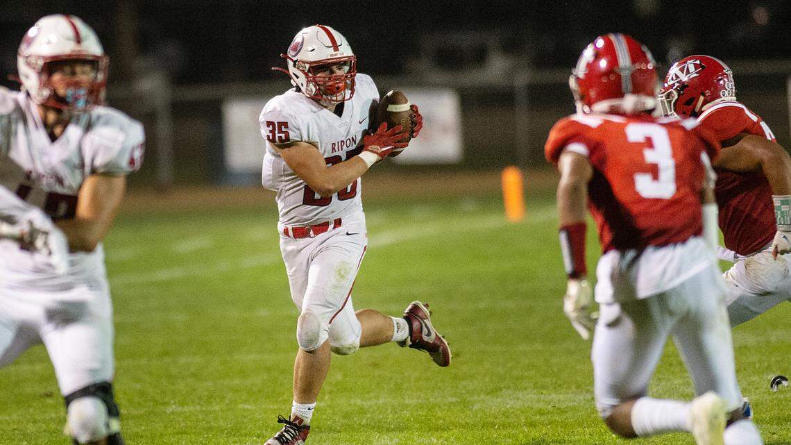 Ripon’s Daniel Espinoza grabs a lateral on a run during a non-league game with Modesto Christian at Modesto Christian High School in Salida, Calif., on Friday, Sept. 17, 2021. Ripon won the game 56-12.