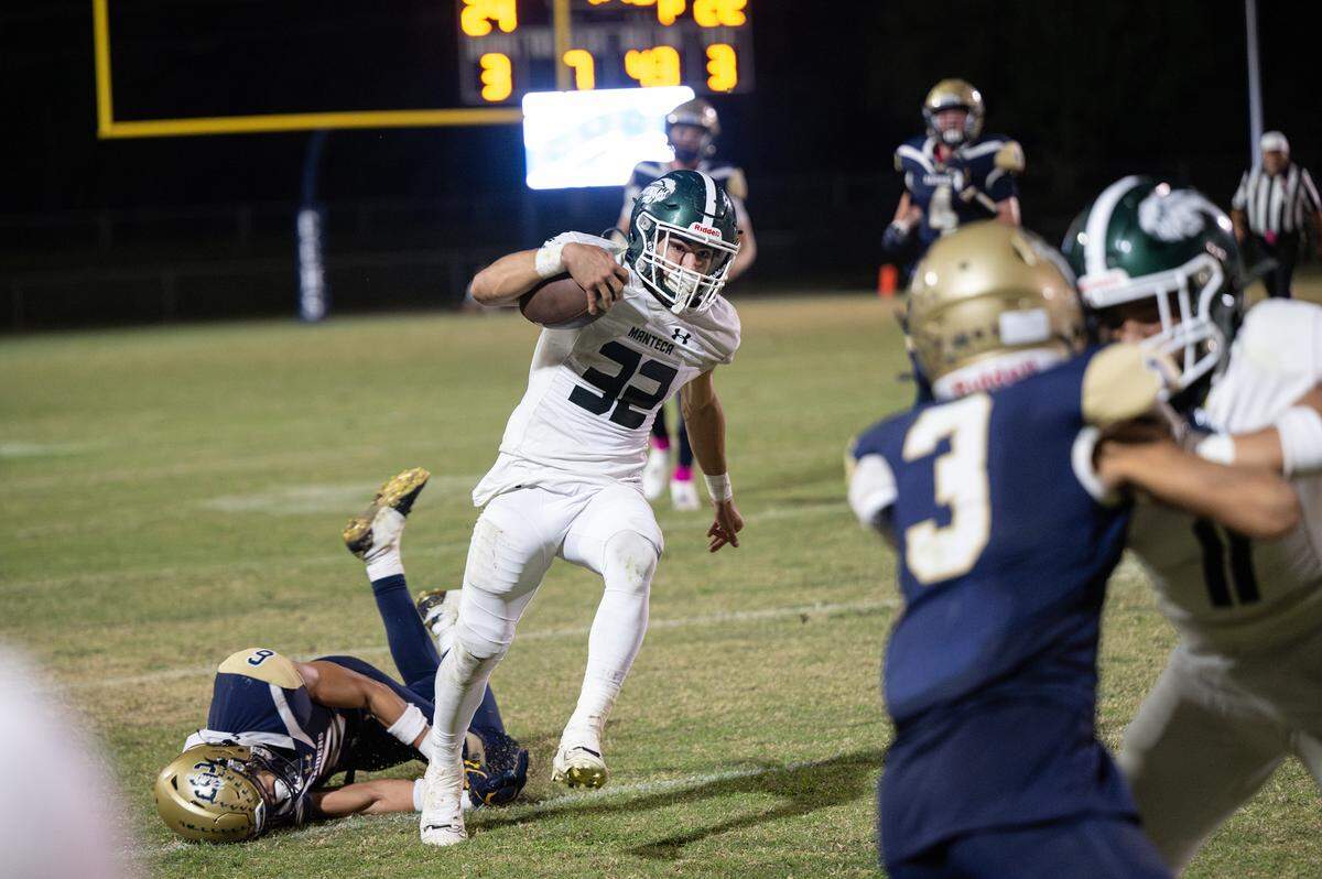 Manteca’s Nikko Juarez breaks a tackle and scores a touchdown on a run during the Valley Oak League game with Central Catholic at Central Catholic High School in Modesto, Calif., Friday, Oct. 20, 2023.