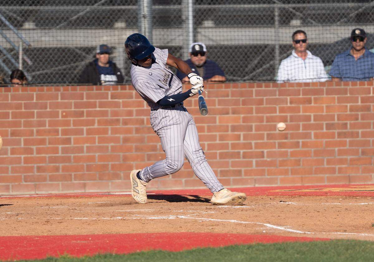 Central Catholic’s Ramon Hinojosa hits an RBI single during a Valley Oak League game against Oakdale at Oakdale High School on  Monday, April 13, 2026.