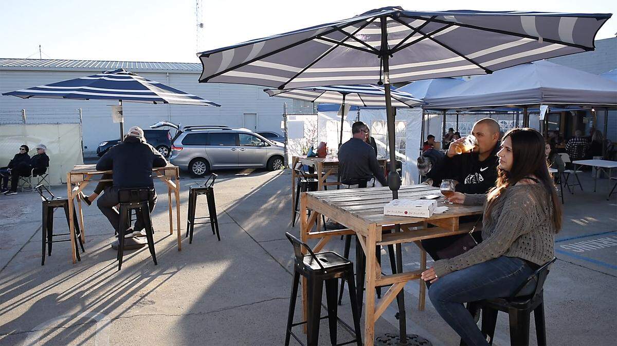 Leo and Ana Rivas, right, and other guests enjoy live music and beer at contentment Brewing Co. in Modesto, Calif., on Saturday, March 6, 2021.