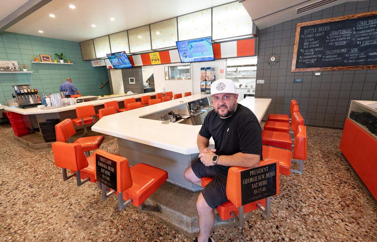 Latif’s restaurant owner Nick Pedretti sits in the spot where former president George H.W. Bush and First Lady Barbara sat for lunch in 1988.