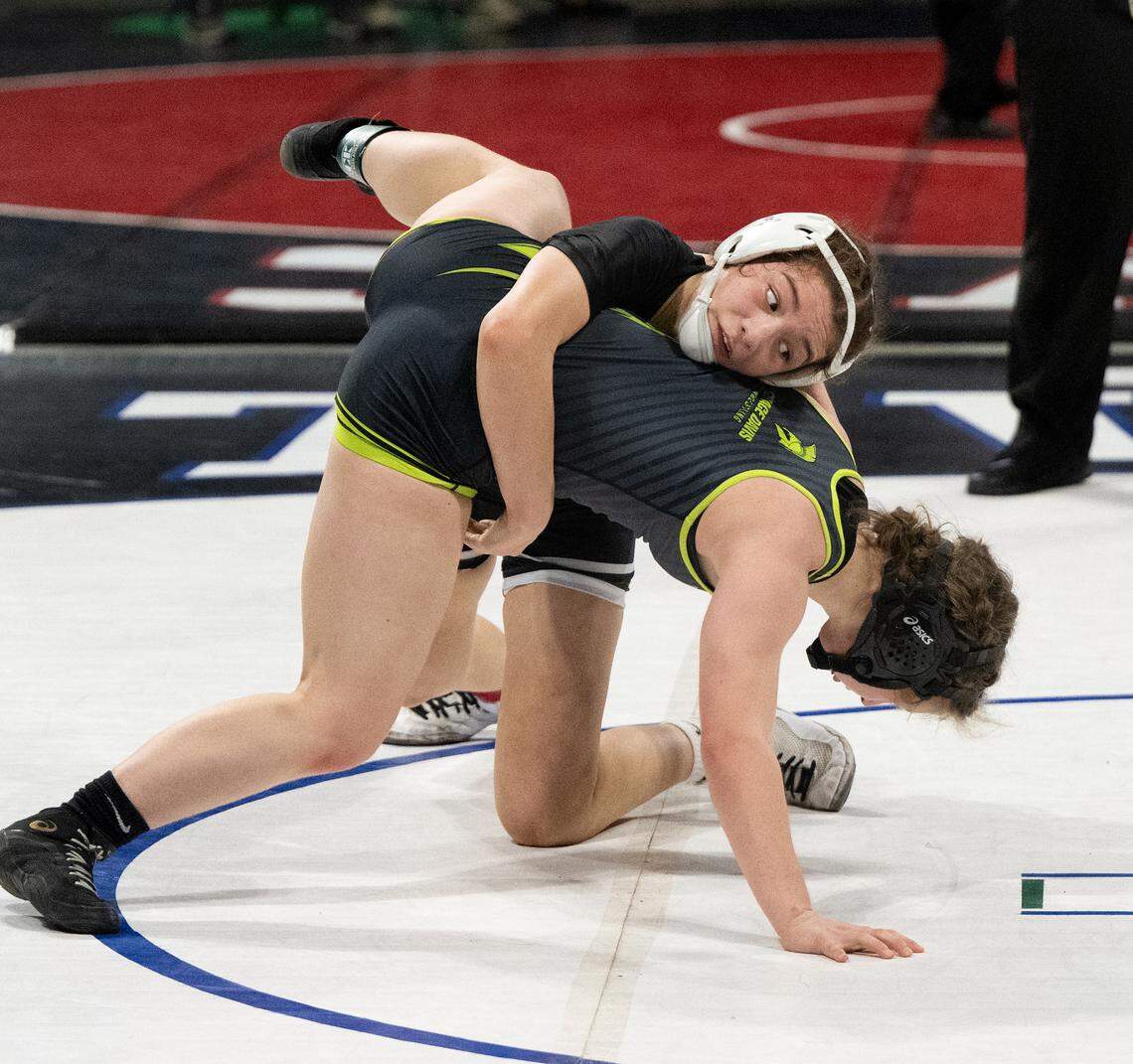 Pitman’s Yzabella Austin and Sophia Hejnal of Grace Davis battle it out in the 130-pound title match during the Sac-Joaquin Section Masters Wrestling Championships at Stockton Arena in Stockton, Calif., Saturday, Feb. 17, 2024. Hejnal won the match 5-4.