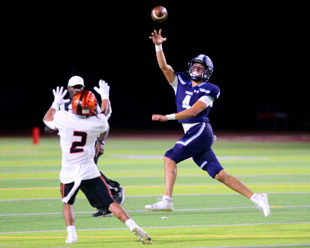 Downey quarterback Joseph Ramirez (4) jumps to throw over a defender during a game between Downey High School and Merced High School at Downey High School in Modesto California on September 1, 2023.
