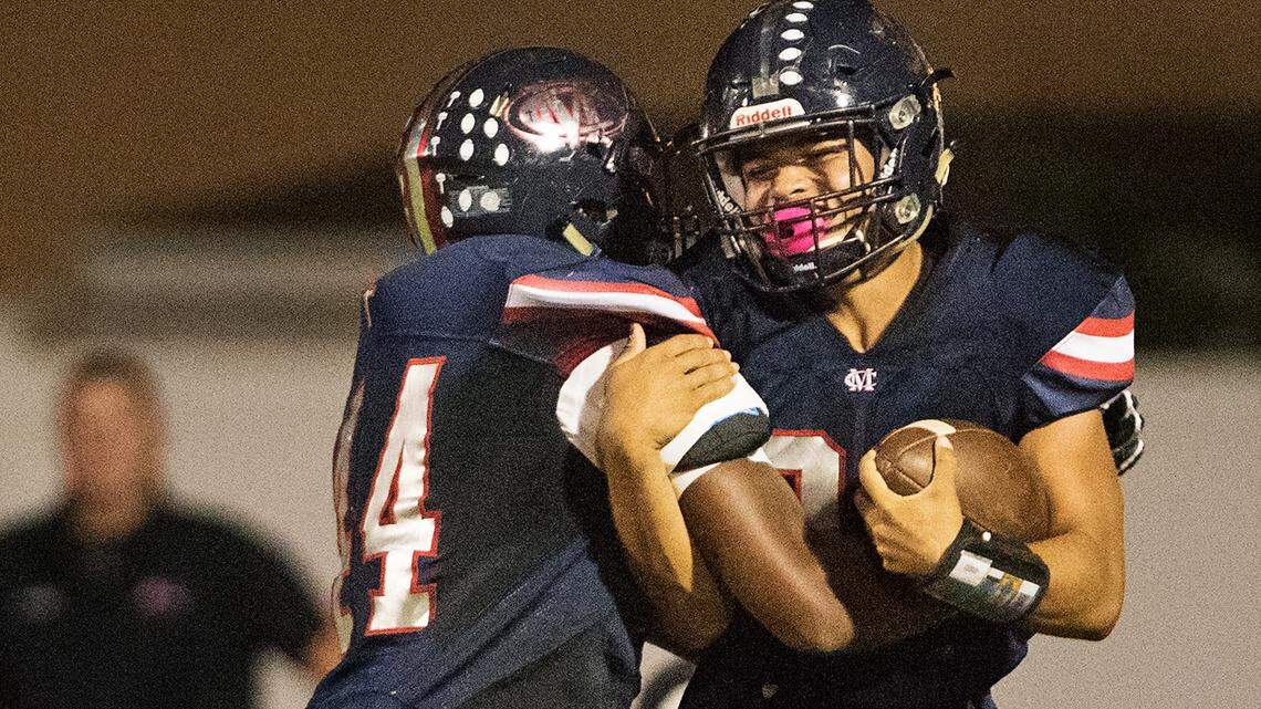Modesto Christian’s Xavier Carlton, left, celebrates with  Patrick Garcia after Garcia’s touchdown against El Capitan in September.
