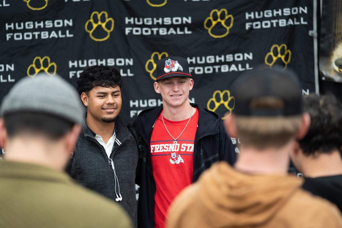 Hughson High School football player Bryce McDaniel takes a picture with teammate Valente Soria after signing with Fresno State on National Signing Day in Hughson on Wednesday, Dec. 3, 2025.