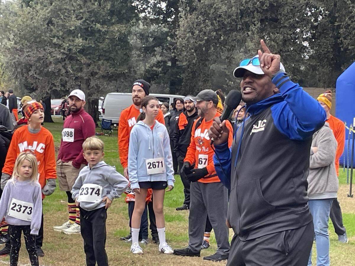 Young runners get instructions from Demitrius Snaer at the Turkey Trot on Nov. 27, 2025, in Modesto, Calif. It raises money for the track and cross country teams at Modesto Junior College. Snaer coaches the men’s teams.