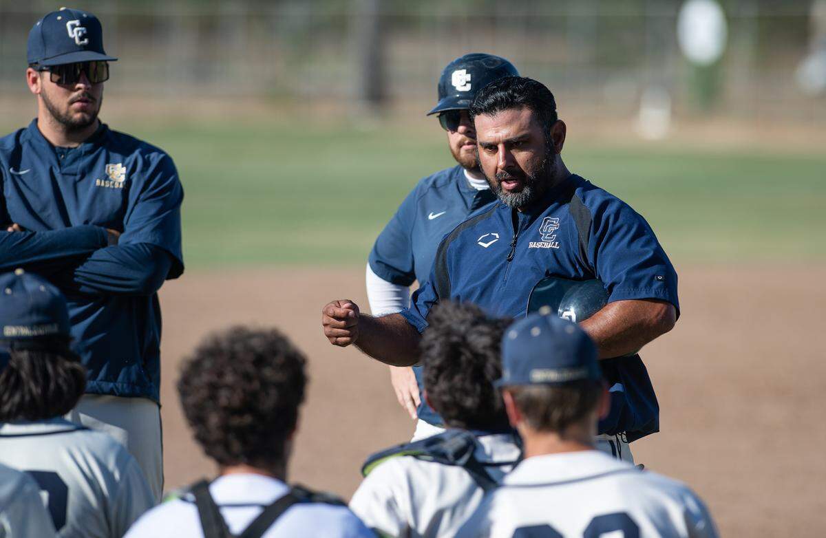 Central Catholic coach Danny Ayala, right, talks with his players after a 6-1 victory over Vanden in the CIF Sac-Joaquin Section Division III semifinal game at Central Catholic High School in Modesto, Calif., on Wednesday, May 18, 2022.