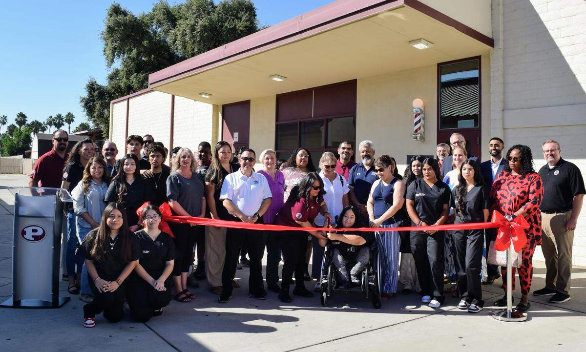 Community members cut the ribbon at the launch of Patterson High School’s new Barbering and Cosmetology Building on Aug. 9, 2025.