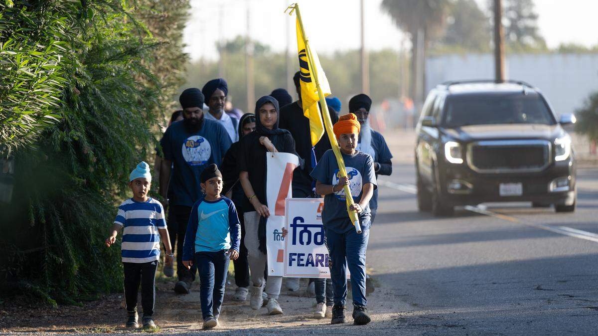Marchers walk toward the Gurdwara Sikh Temple in Ceres, as part of The Fearless for Justice March Thursday, Oct. 24, 2024. The 350-mile march, organized by the Jakara Movement, advocates for recognition of the 1984 Sikh killings and anti-Sikh violence in India as a genocide. The march culminates in Sacramento on Nov.1.