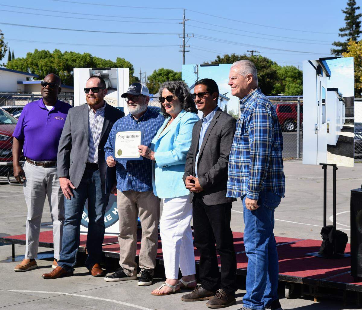 Modesto City Councilmember Jeremiah Williams, Modesto Gospel Mission CEO Jason Conway, COO John Villines, Mayor Sue Zwahlen, and Councilmembers Eric Alvarez and David Wright pose with a certificate during the grand opening of Grace Gardens on Aug. 15, 2025.