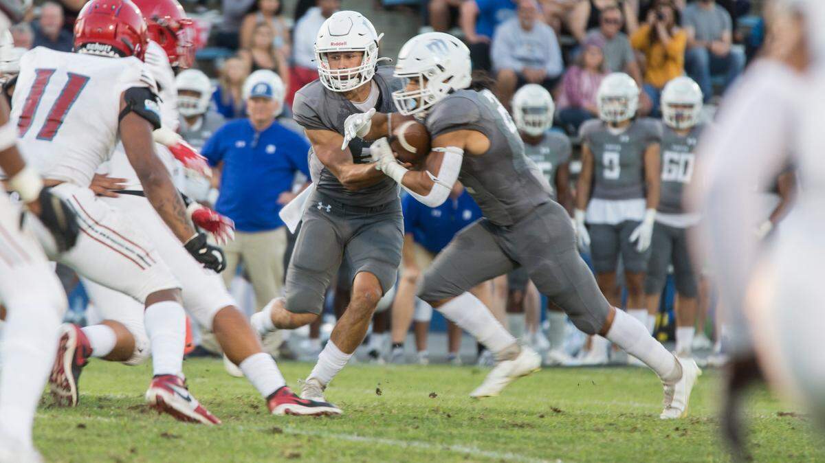 Gino Campiotti, 3, hands the ball off to Anthony Frias, 22, as a wall of San Francisco City College defense lines up. Modesto Jr College football vs San Francisco City College Saturday Sept. 18, 2021 at Modesto Jr College.