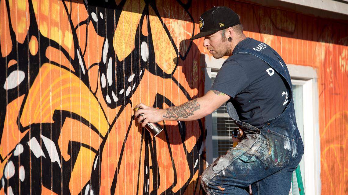 Graffiti artist Cameron Moberg paints a mural on the exterior of “youth house” at the Modesto Free Will Baptist Church on Orangeburg Avenue in Modesto, Calif., Saturday, Jan. 12, 2019. Moberg, know by his tag Camer1, has used a anonymous donation to remodel the exterior of the building including his mural work.