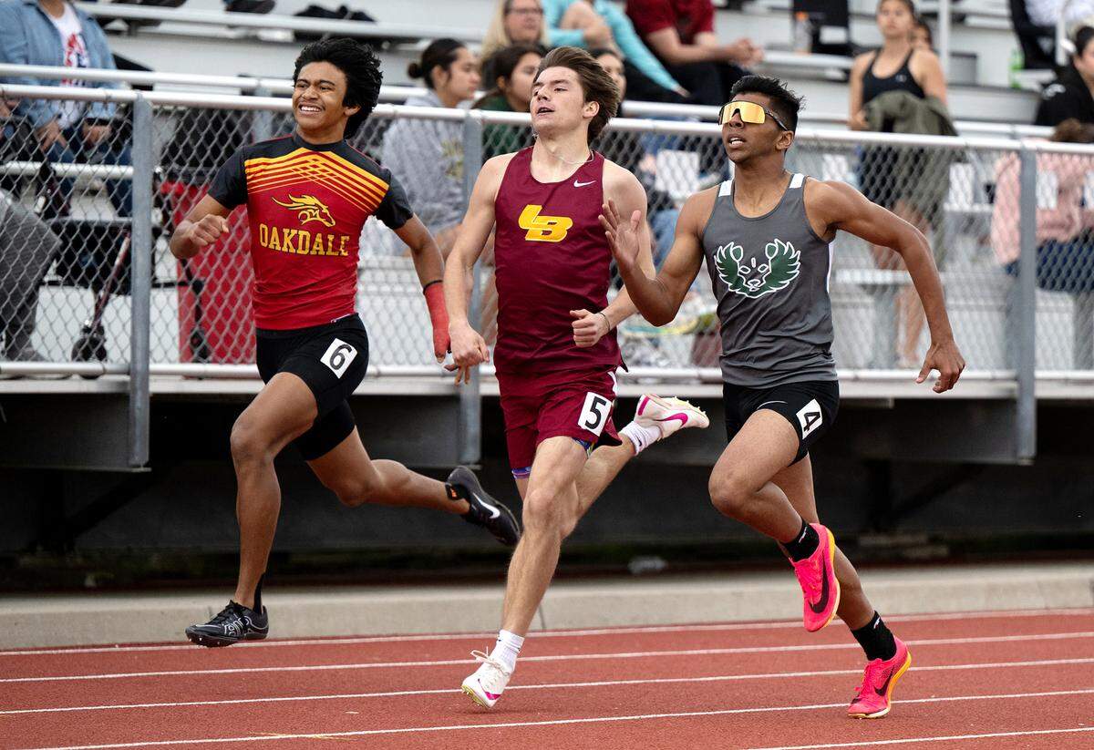 Varsity runners Pitman’s Aric Singh (4) of Los Banos (5) Caleb Robertson and Oakdale’s Rafael Rios (6) run in the 400 meter race during the County Clash track meet at Oakdale High School in Oakdale, Calif., Friday, March 22, 2024. Singh place third at 52.62, Robertson 4th at 52.66 and Rios 6th at 52.98.