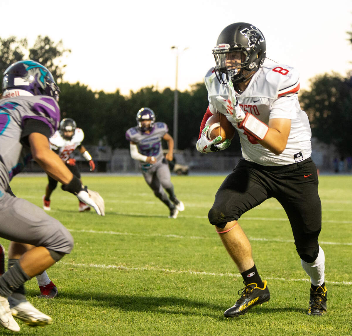 Heston Blom, 8, of Modesto High works his way up field against Johansen High Friday August 19, 2022.