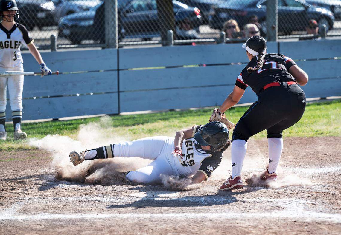 Enochs’ Vivian Hurst as Modesto’s Aaliyah Williams applies a tag without the ball during the Central California Athletic League game with Enochs in Modesto, Calif., Tuesday, April 18, 2023.