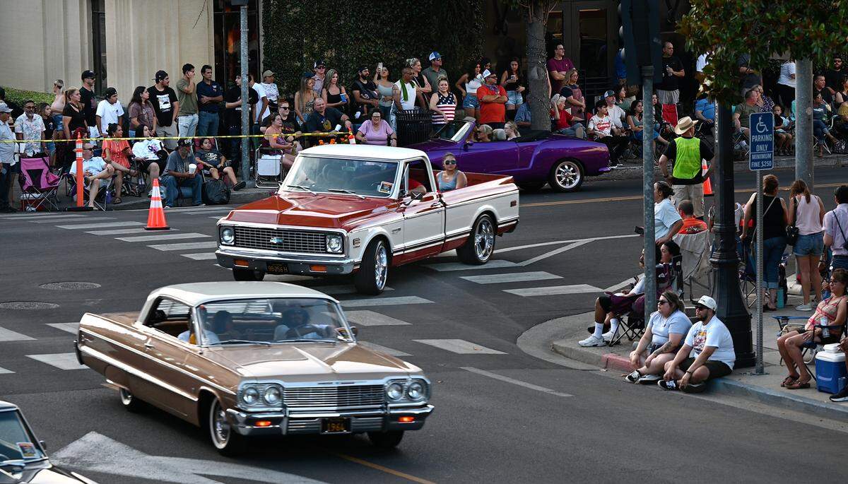 Classic car owners turn onto 11th Street during the North Modesto Kiwanis Club’s “American Graffiti” car parade in Modesto, Calif., on Friday, June 10, 2022.