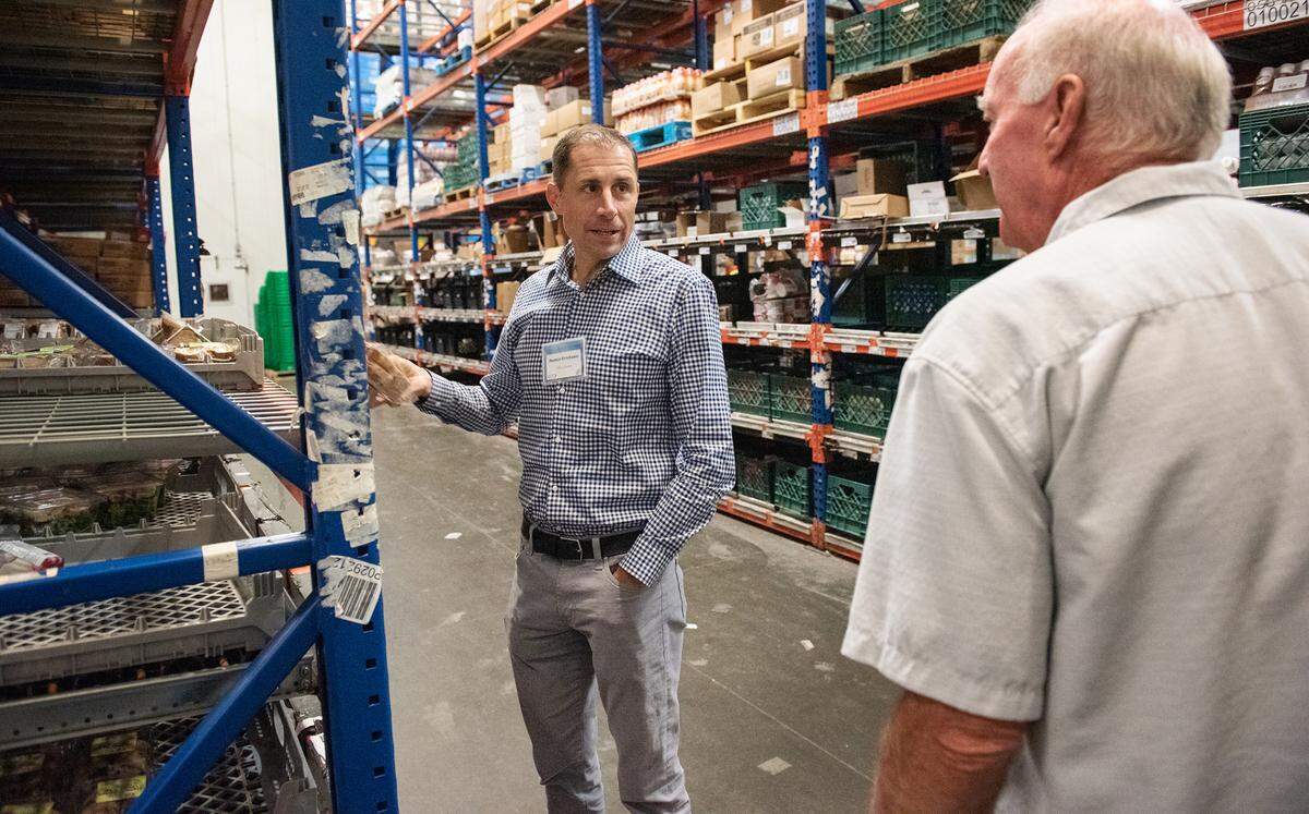 Justin Erickson, CEO of Harbor Foods, left, talks with MTC Distributing owner Tom Eakin at MTC warehouse in Modesto, Calif., Tuesday, Oct. 25, 2022. Eakin has sold the 101-year-old Modesto company to Harbor Foods, a family owned distributer from Washington state.