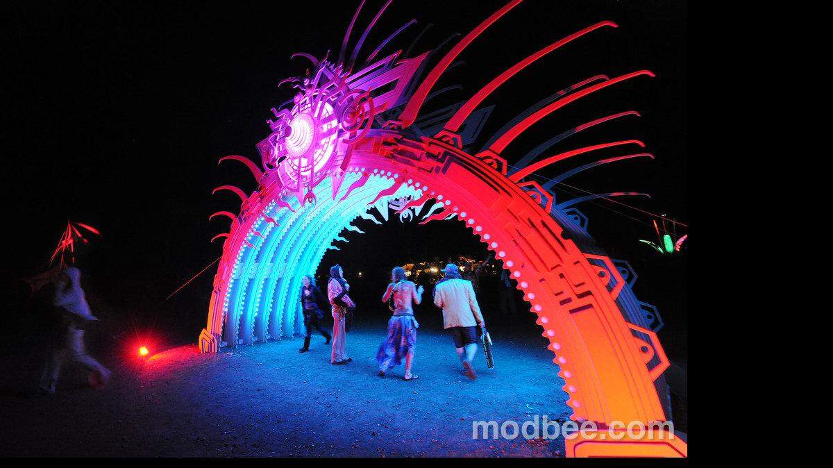 Festival goers interact with one of the many colorful and vibrant art pieces that take on a completely different feel in the dark during the closing nocturnal events of the 2013 Symbiosis Gathering held at Woodward Reservoir just north of Oakdale Sunday night (09-22-13).