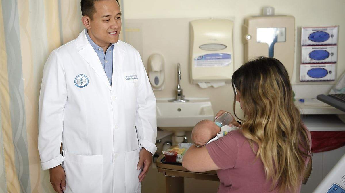 Kaiser pediatrician Marcial Salvador talks with new mother Barbara Baglione at Kaiser Hospital in Modesto. Can California prevent health care cuts by taxing the rich? Learn how Medi-Cal, Prop 35, and federal restrictions shape the state’s health care future.