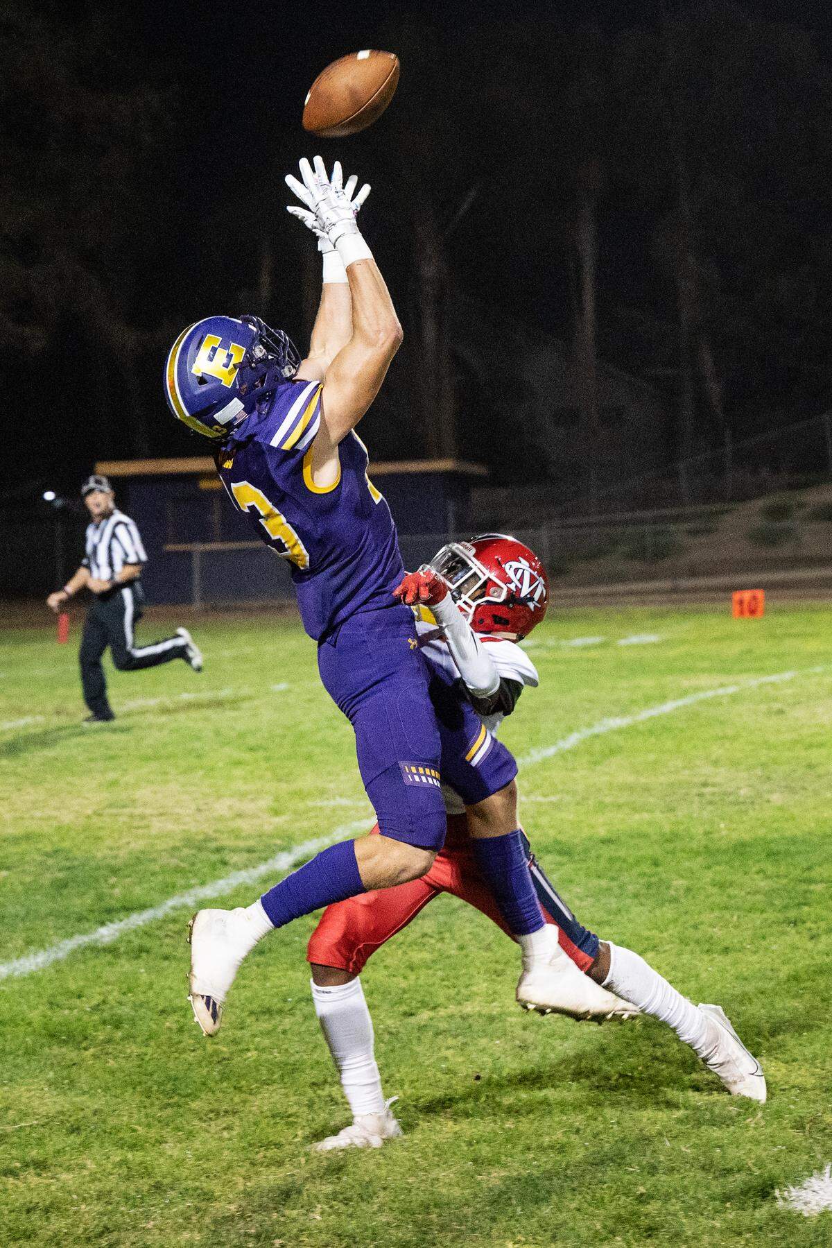 Escalon’s Owen Nash makes a catch and runs the ball in for a touchdown as Modesto Christian’s Donovan Jones defends during the Trans-Valley League game in Escalon, Calif., Thursday, Oct. 6, 2022. Escalon won the game 62-30.