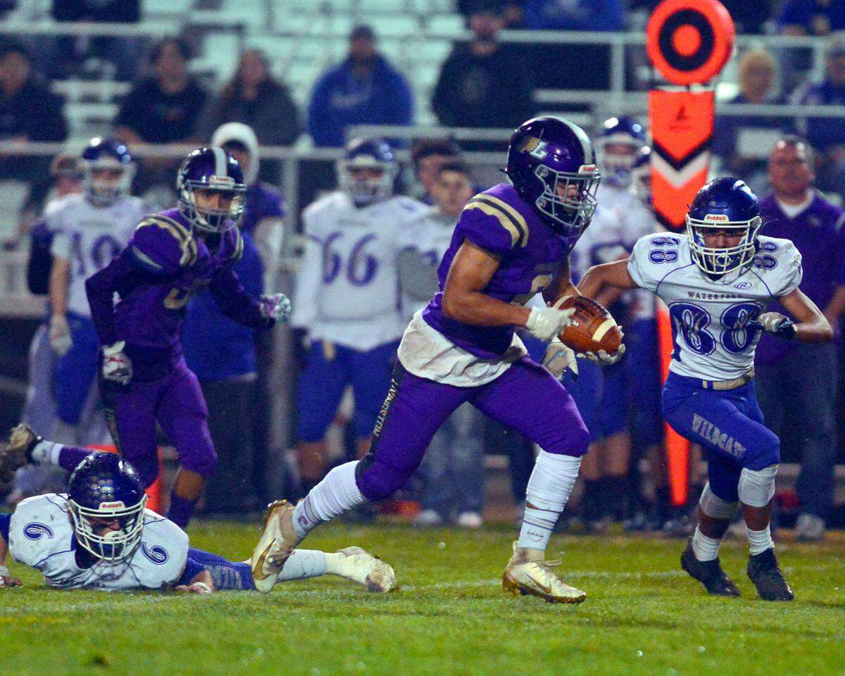 Livingston running back Carlos Baez (6) breaks free to score a touchdown during a 2021 CIF Sac-Joaquin Division VI playoff game between Livingston High School and Waterford High School at Livingston High School in Livingston, California on November 12, 2021