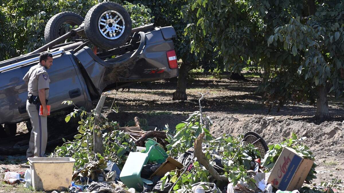 The California Highway Patrol investigates a fatal, single-vehicle crash into a walnut orchard on the 3800 block of Paradise Road southwest of Modesto on Sunday afternoon, Sept. 29, 2019. The tubs, patio furniture and other belongings strewed on the ground came from the bed of the pickup truck.