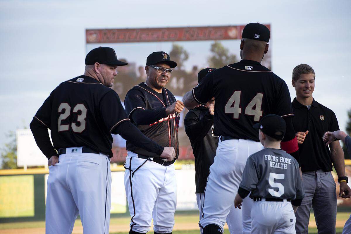 Modesto Nuts coaches and players are introduced before the opening day game with the Stockton Ports at John Thurman Field in Modesto, Calif., Thursday, April 11, 2019.