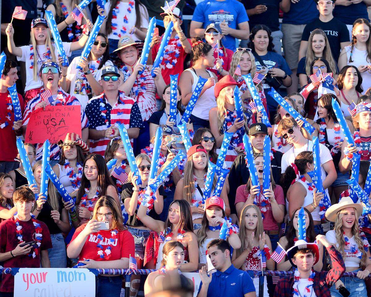 The Hughson High School Student section wears patriotic attire while cheering during a game between Hughson High School and Central Valley High School at Hughson High School in Hughson California on August 25, 2023.
