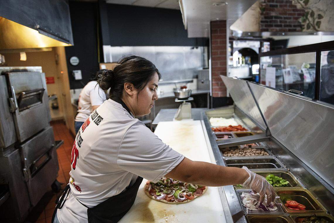 Fatima Cortez makes a pizza at Rico’s Pizza in Turlock, Calif., on Wednesday, May 13, 2020.