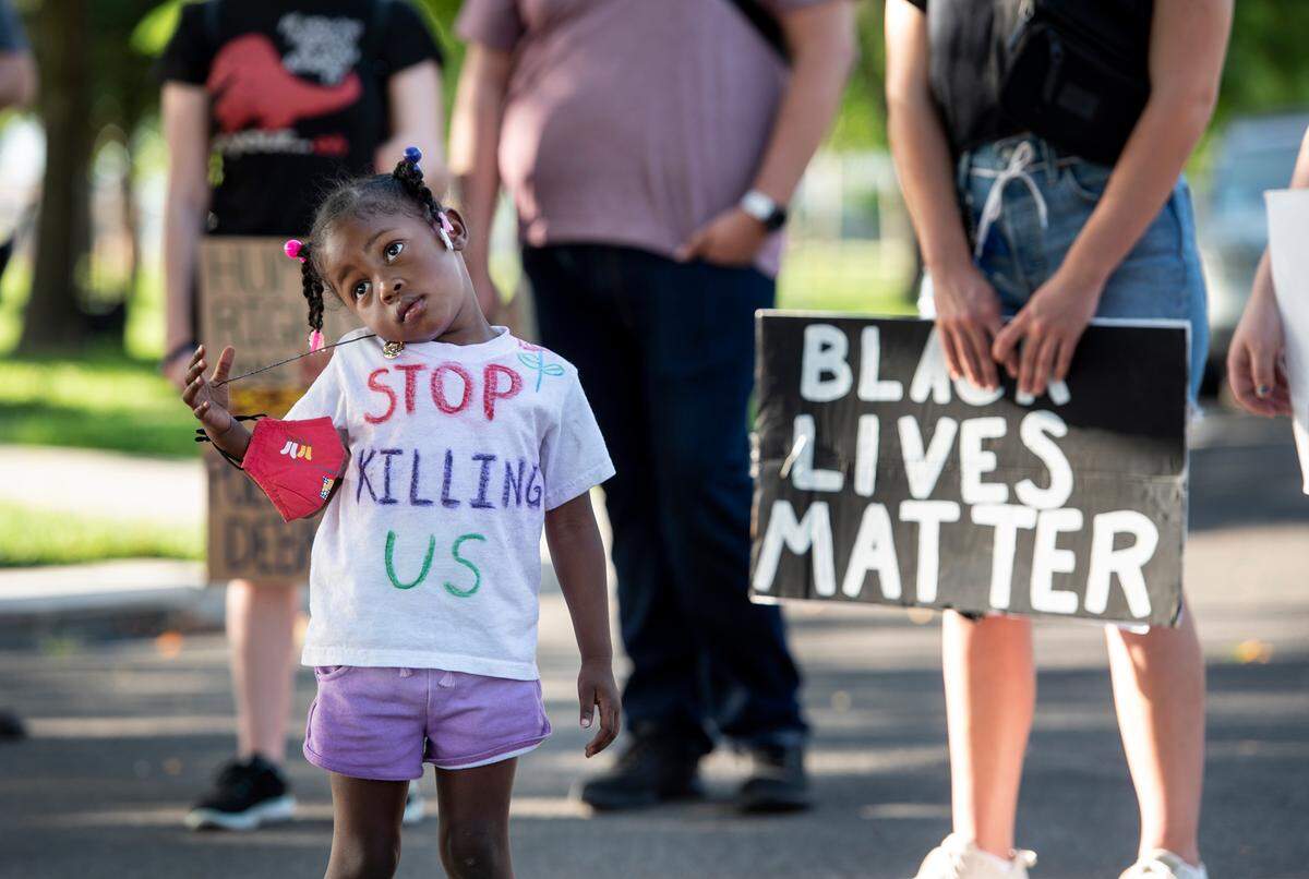 Nai’lah Brenda, 3, listens during a Black Lives Matter gathering in Turlock, Calif., on Saturday, June 20, 2020.