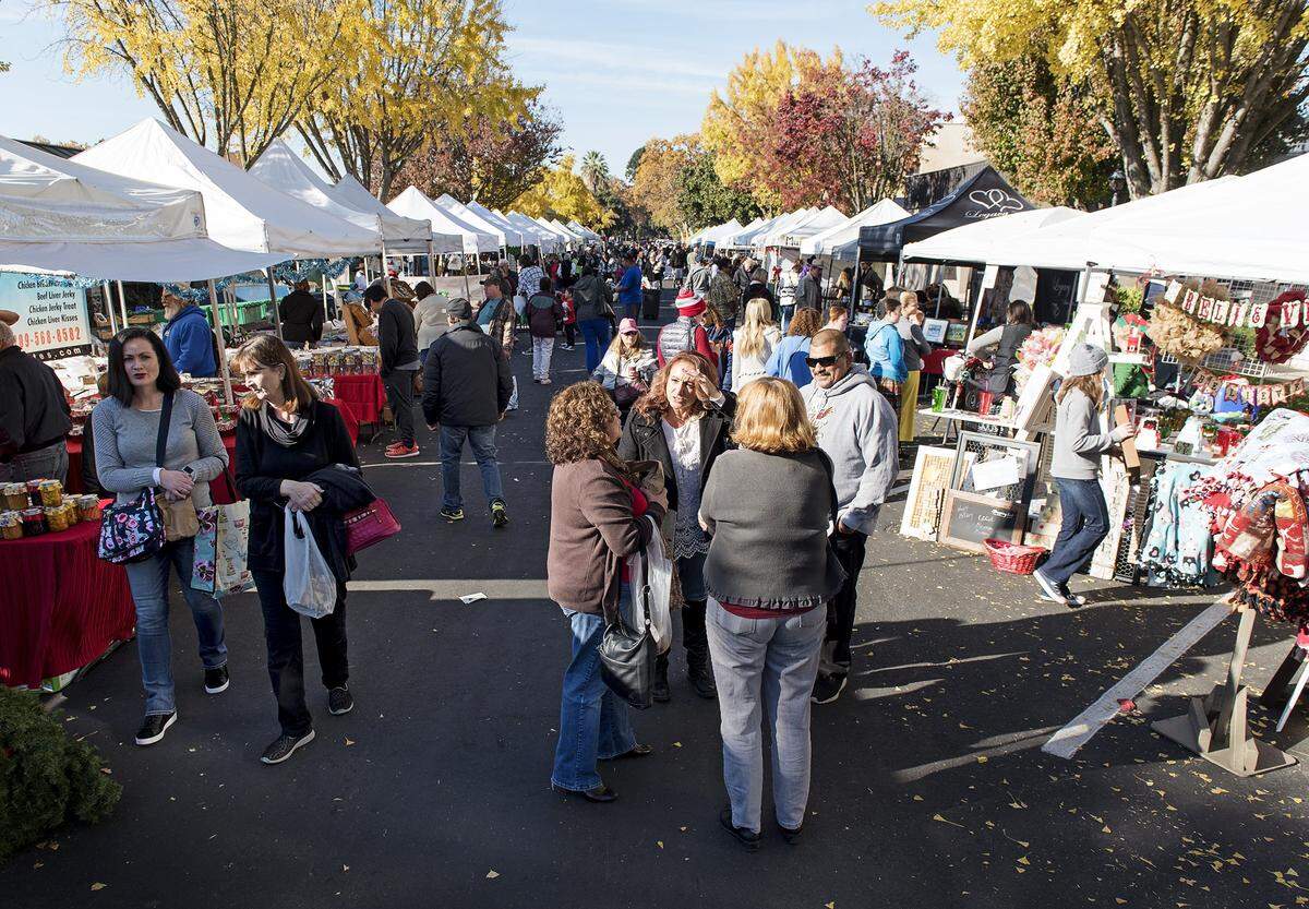People shop and browse during a past year’s Dickens Faire outside the McHenry Mansion.2016.