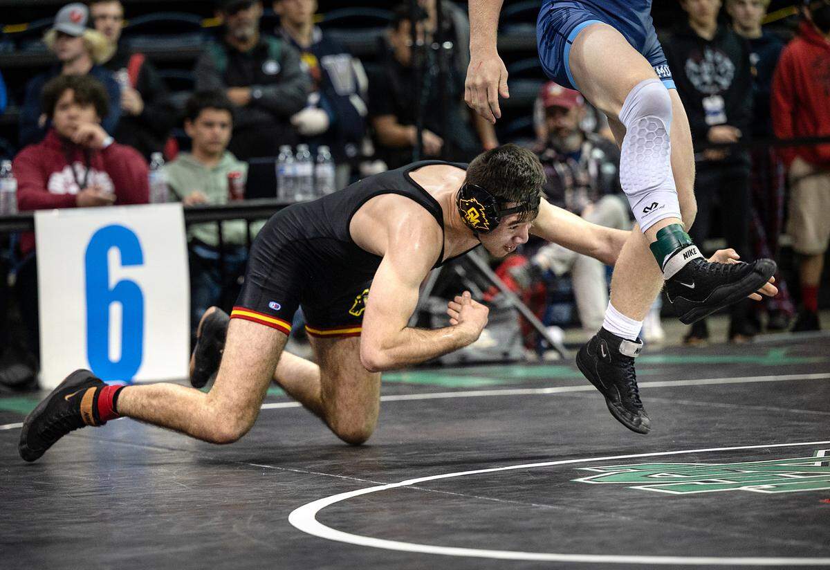 Carlos Garcia of Oakdale lunges at Oakmont wrester Danny Myles in the 160-pound championship match during the CIF Sac-Joaquin Section Masters Wrestling Tournament at the Stockton Arena in Stockton, Calif., on Saturday, Feb. 19, 2022. Garcia won 7-2 for first place.
