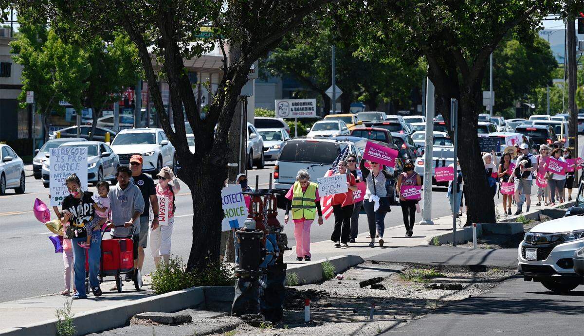 Participants march down McHenry Avenue as hundreds rally for abortion rights in Modesto, Calif., on Saturday, May 14, 2022.