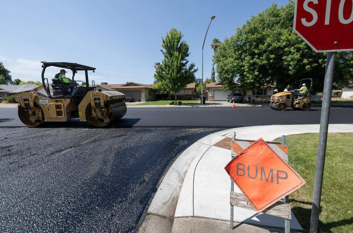 A crew from United Pavement Maintenance Inc. resurfaces Orangeburg Avenue from Coffee Road to Oakdale Road in Modesto, Calif., Thursday, June 22, 2023.