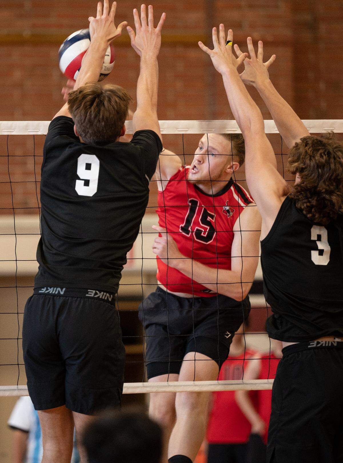 Modesto’s Cole Rogers spikes the ball past Pitman defenders during the Central California Athletic League match in Modesto, Calif., Thursday, April 27, 2023. Rogers had 49 kills in the five-set victory.