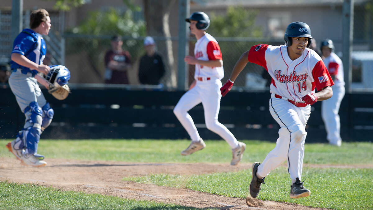 Modesto’s EJ Esparza, right, drives in a run during the Windemuth Tournament championship game with Ripon Christian at Modesto High School in Modesto, Calif., Thursday, April 13, 2023.