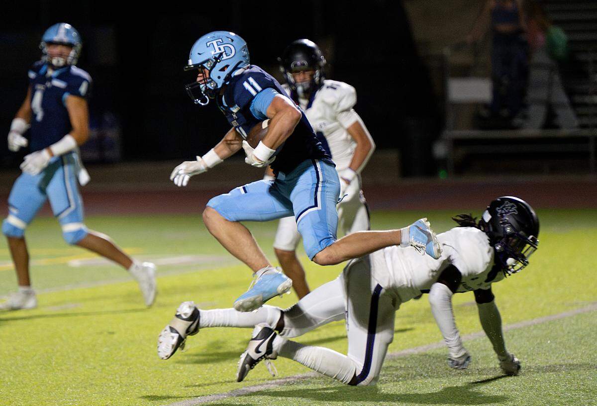 Downey’s Ethan Woodmansee runs the ball after a reception during the game with Amador Valley at Downey High School in Modesto, Calif., Friday, Sept. 13, 2024.