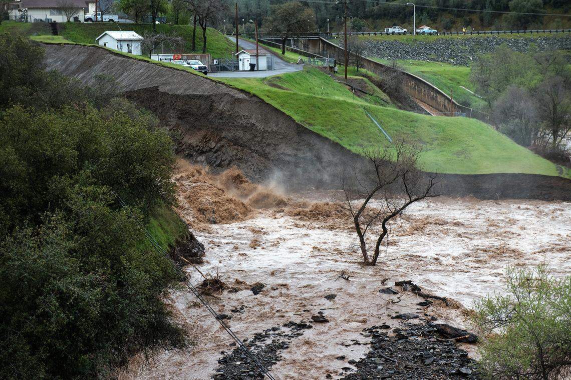 Water rushes through the secondary spillway at the Moccasin Reservoir in Moccasin, Calif., on Thursday March 22, 2018.