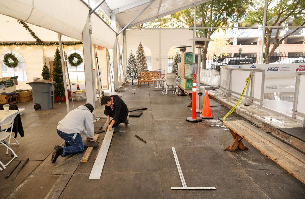 Gabriel Medina and Jonny Rontal, left, prepare the Modesto on Ice venue for opening day in downtown Modesto, Wednesday, Nov. 20, 2024. The skating season opens Saturday.