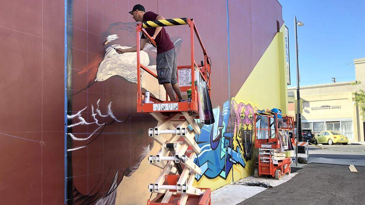 Artists work during the 2018 Fasm Creative Battle. This year, artists will paint on two walls in downtown Modesto.